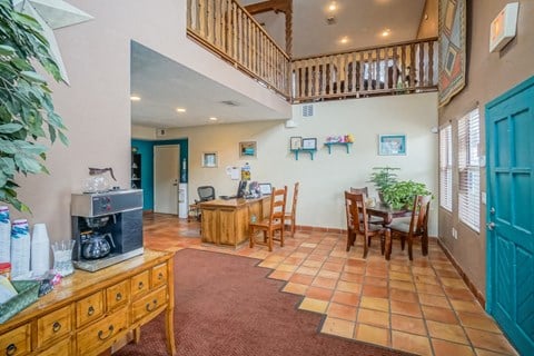 a living room and dining room with a table and chairs